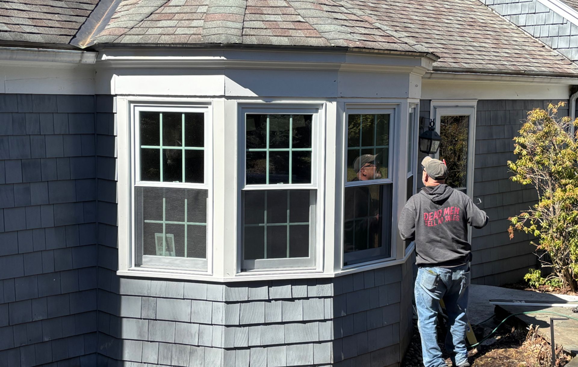 NH Total Home Care team member working on an exterior window project